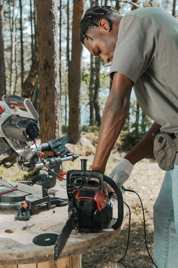 Man Starting a Chain Saw on a Construction Site